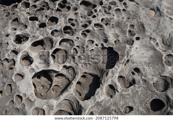 texture of porous stones on the beach,\
nature, natural phenomena, brown-gray\
stones