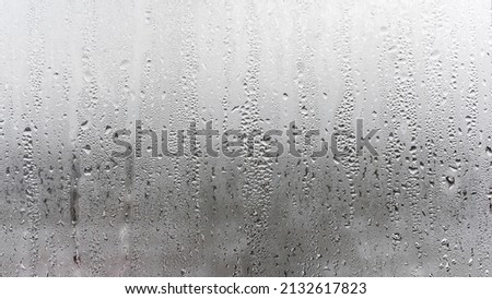Texture of the rain on the glass, steamy window with water drops made in dull day