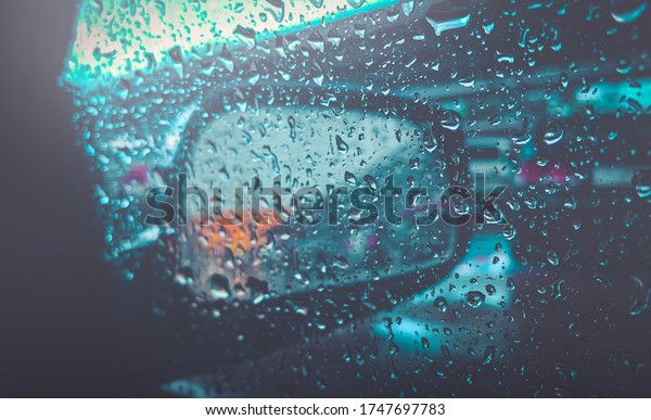 Texture\
rain water droplets of various shapes illuminated  bokeh Blur my\
car side mirror CINEMATIC LOOK blue dark\
tone.