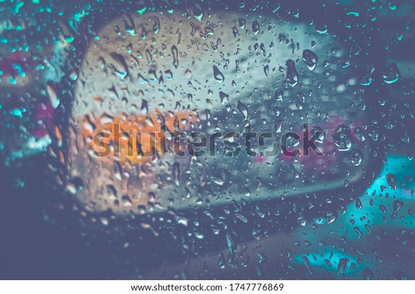 Texture rain\
water droplets of various shapes illuminated bokeh Blur my car side\
mirror CINEMATIC LOOK blue dark\
tone.