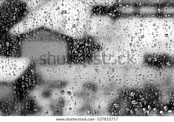 Texture Raindrops on  window glass for\
rain, black and white colors, photo, unusual\
background