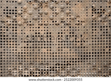 Texture of a random perforated metal with rounds bevel, with corroded and rusty metal plate. Oxidized perforated metal plate texture.