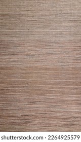 texture of rectangular sisal rug mixing threads in brown, burgundy and beige.