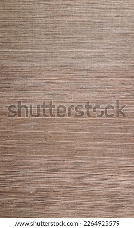 texture of rectangular sisal rug mixing threads in brown, burgundy and beige.