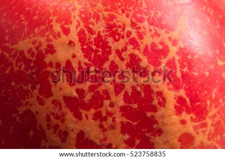 Texture of a red apple peel. Skin of apple close-up. Shallow depth of field
