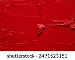 Texture of red lipstick or acrylic paint. Energetic color. The image is suitable for use in cosmetic companies, fashion magazines, art projects, promotional material and packaging design.