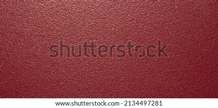 The texture of the red matte plastic.Red matte background.The background is red rough plastic.