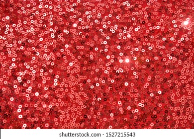 Texture of red pearlescent sequins, macro photo
