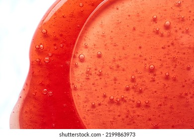 The Texture Of The Red Transparent Cosmetic Gel. Abstract Background