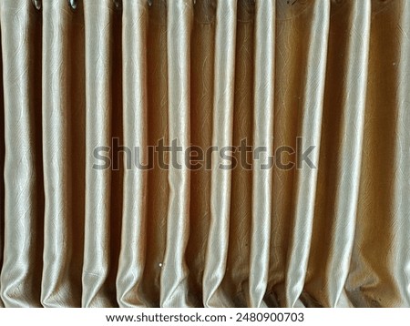 Texture, repeating pattern of wavy curtains, gold curtains, looks dignified for the background.