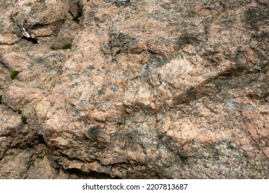 Texture Of Rock. Fragment Of Pink Granite Stone Wall.  Natural Rock Textured Background. Selective Focus