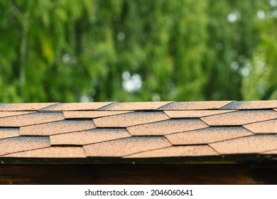 The Texture Of The Roof Of The Gazebo, Covered With Soft Bitumen Tiles Of Orange-brown Color Close-up