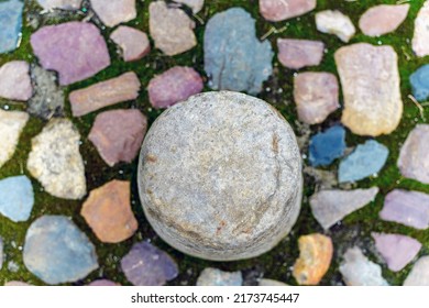 Texture. Round stone in the center. Nearby multi-colored stones blurred - Shutterstock ID 2173745447