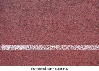 Texture Of Rubber Running Track On The Stadium, Athletics Sport Background, Top View Of Red Racetrack Surface With White Stripe