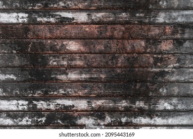 Texture of rural stained exterior black rot oak planks of country barn.Old dirty rough of gnarled surface wooden panel parquet.Rustic messy grungy lumber fence of hard laths for 3D siding style design