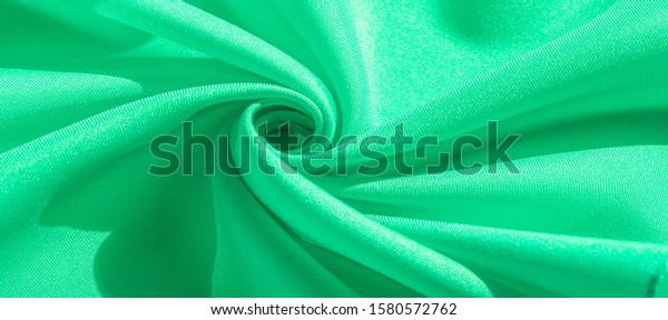 Texture, silk fabric of green color, solid\
light green silk satin fabric of the duchess Really beautiful silk\
fabric with satin sheen. Ideal for your design, Special Occasion\
Wedding Invitations