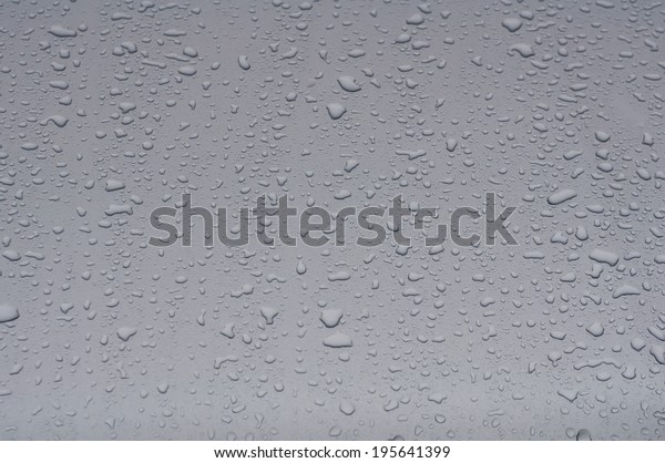 Texture silver hood\
of the car with\
raindrops