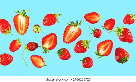 Texture of sliced strawberries on blue background. Bright natural abstract wallpaper made of food. Banner image.