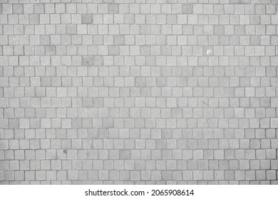 Texture of small cobblestones of a sidewalk or street. Gray cobblestones. Cement squares. Square stone. Texture for matte painting.