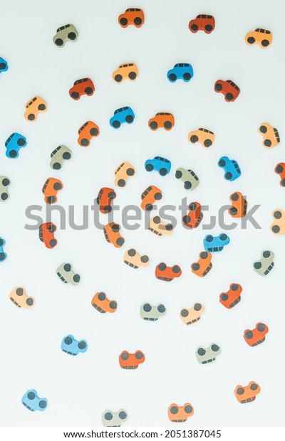 Texture of small multi-colored toy cars moving in\
a circle isolated on a white background, Top view depicts a\
circular motion.