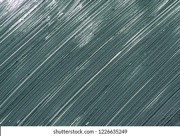 Texture and smear of dark green mascara for eyelashes isolated on white background