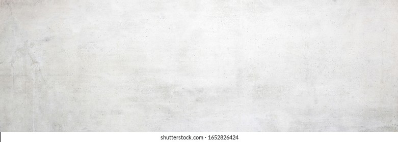 Texture of a smooth white concrete wall with cracks as a background or wallpaper