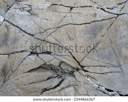 Texture of stone with cracks and scratches. The surface of the stone.       