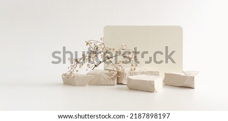 Texture stone platform eco podium and empty card on gray beige copy space horizontal long background. Minimal still life display product presentation scene.