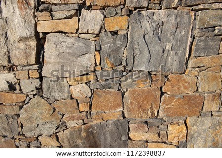 Texture of the stone wall. The displayed wall is built of slate from the local quarry.
