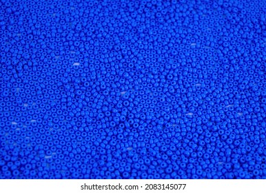 The texture of the surface of scattered blue beads for needlework. Beads for women's needlework. Blue round granules. Textured effect. Background image. Template for text. - Powered by Shutterstock