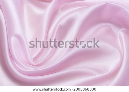 The texture of the synthetic fabric is pink. Background, pattern.