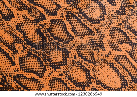 the texture of synthetic leather and brown snakeskin pattern


