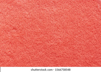The texture of the terry towel is coral color. Abstract red soft fabric background