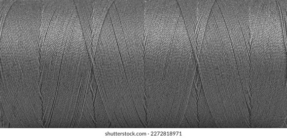 Texture of threads in a spool of grey color on a white background close-up - Powered by Shutterstock