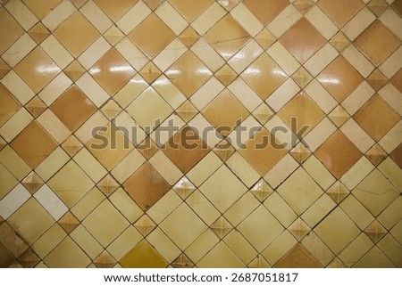 The texture of the tiles on the wall