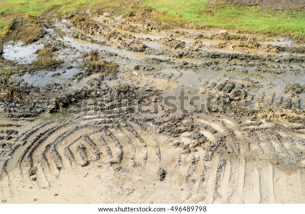Texture of tractor\
wheels in mud\
background.