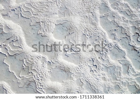 Texture of travertine. Ribbed surface formed by flowing mineral water from geothermal hot spring