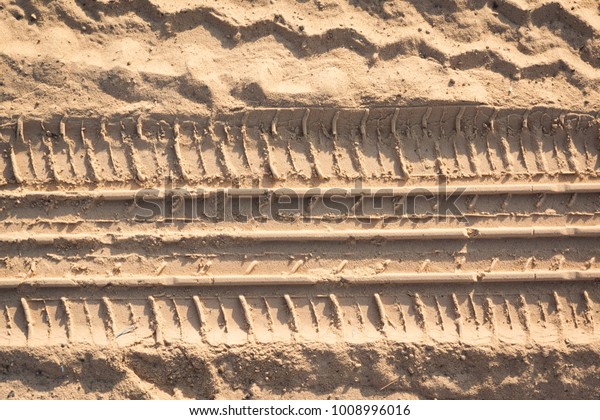 texture of tyre\
track pattern on the sand\
ground