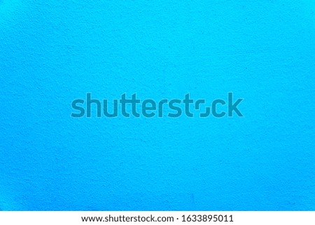 Texture of an uneven wall with rough edges, blue background close-up