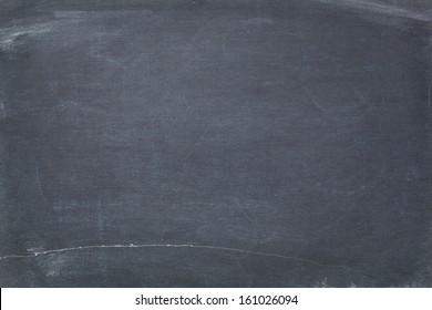 Texture Of Vintage Slate Blackboard With Scratches And White Chalk Smudges