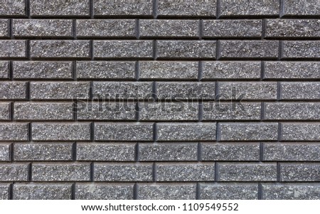 The texture of the wall is made of gray bricks laid horizontally