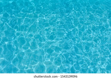 Texture Of Water Surface. Overhead View, Swimming Pool Bottom Caustics Ripple And Flow With Waves Background.