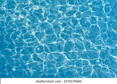 Texture Of Water Surface. Overhead View, Swimming Pool Bottom Caustics Ripple And Flow With Waves Background.