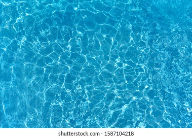 Texture Of Water Surface. Overhead View, Swimming Pool Bottom Caustics Ripple And Flow With Waves Background.