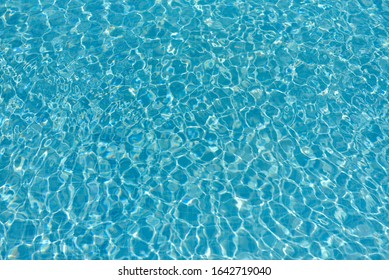 Texture Of Water Surface. Overhead View, Swimming Pool Bottom Caustics Ripple And Flow With Waves Background.