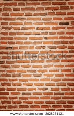 Texture of weathered brown brick wall with vignette.
