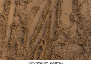 Texture Of Wet Brown Mud With Bicycle Tyre Tracks