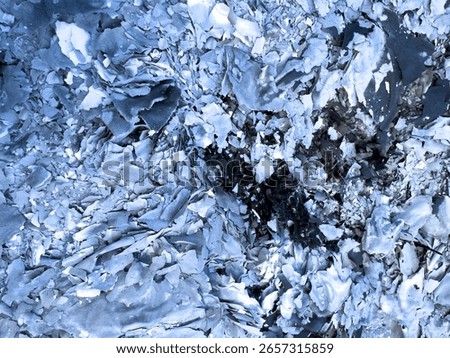 The texture is white gray ash from burnt leaves on the ground. Natural burnt paper.
