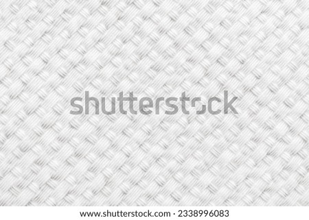 Texture of white material or fabric with interlaced lines in the shape of rhombuses. Gray background