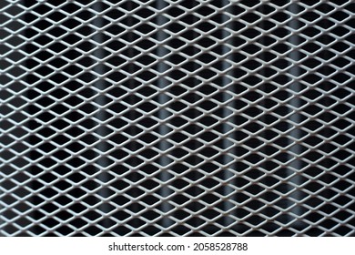 Texture: white metal iron grating, grid or stainless steel grate on black background. Venting, ventilation with geometric design pattern